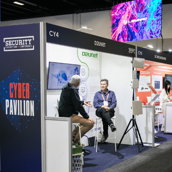 men at their cyber pavilion stand